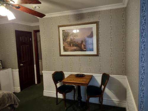 a dining room with a table and two chairs at The King George Inn in Cobourg