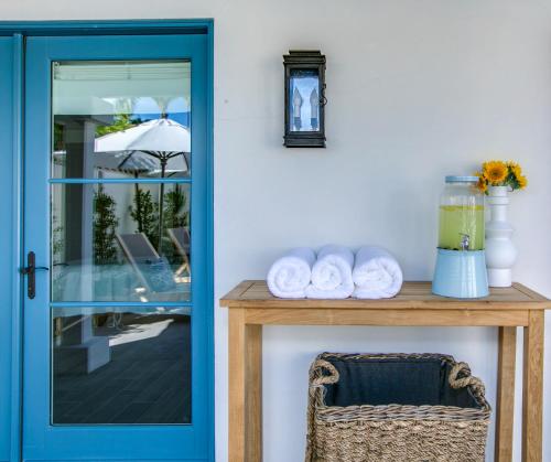 a blue door next to a table with towels at La Serena Villas, A Kirkwood Collection Hotel in Palm Springs