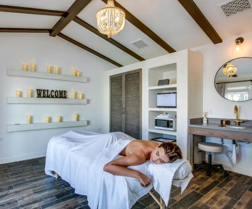 a man laying on a bed in a room at La Serena Villas in Palm Springs