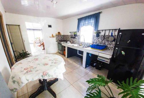 a kitchen with a table in the middle of a room at Casa de las Mariposas in Río San Juan