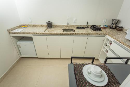 a small kitchen with a counter and a sink at Chalé Mantiqueira - Cunha in Cunha
