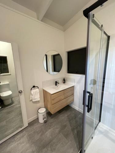 a bathroom with a sink and a shower at Private Water Front House in Whangaparaoa