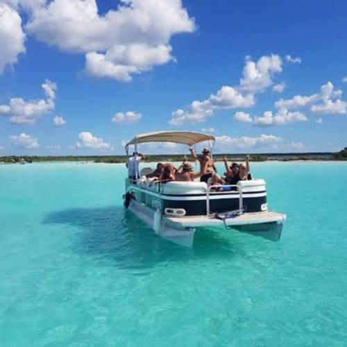 a group of people on a boat in the water at Tours in the lagun in Bacalar