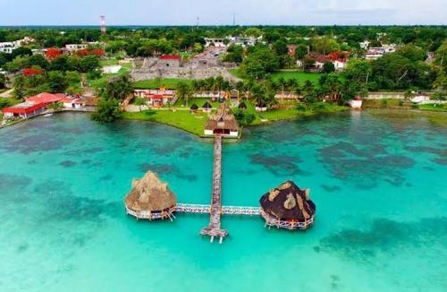 an island with a lighthouse in the middle of the water at Tours in the lagun in Bacalar