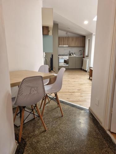 a dining room and kitchen with a table and chairs at Cozy apartment near city center in Bucharest