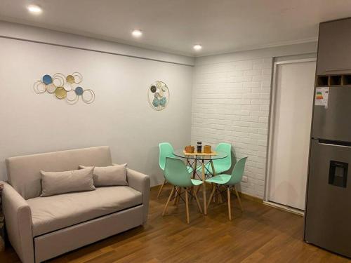- un salon avec un canapé et une table avec des chaises dans l'établissement Lindo Apartamento, full equipado -Factura empresas-, à Quillota