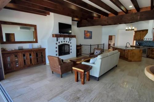 a living room with a couch and a fireplace at Majestic Beachfront Hideaway in Alisitos