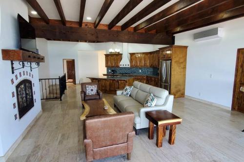 a living room with a couch and a table at Majestic Beachfront Hideaway in Alisitos