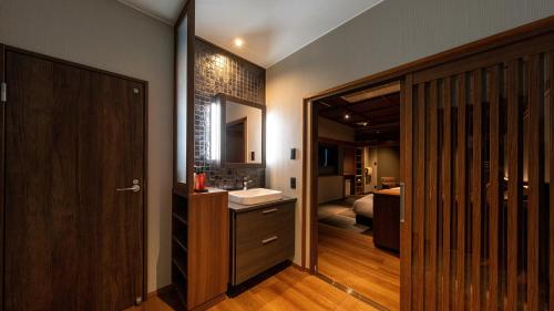 a bathroom with a sink and a mirror at Fukusenka in Ukiha