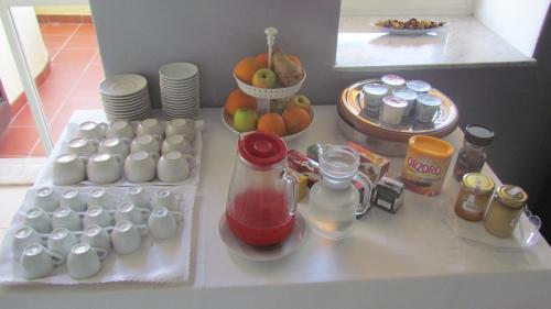 a white table with food and drinks on it at B&B Il Cappero in Lipari