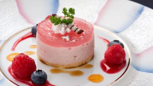 a pink cake with berries on a white plate at Fukusenka in Ukiha