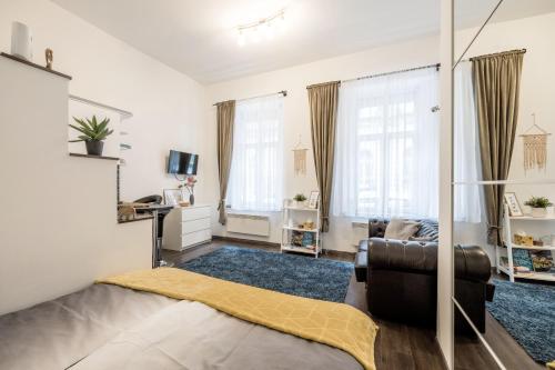 a living room with a couch and two windows at Stylish Downtown Studio in Budapest