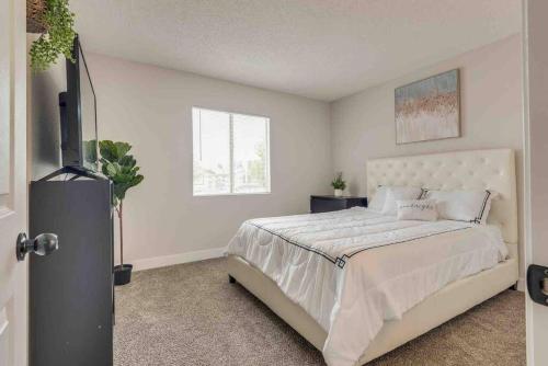 a bedroom with a large bed and a window at Cozy home! 16 Min away from strip and fremont in Las Vegas