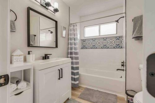 a white bathroom with a sink and a shower at Cozy home! 16 Min away from strip and fremont in Las Vegas