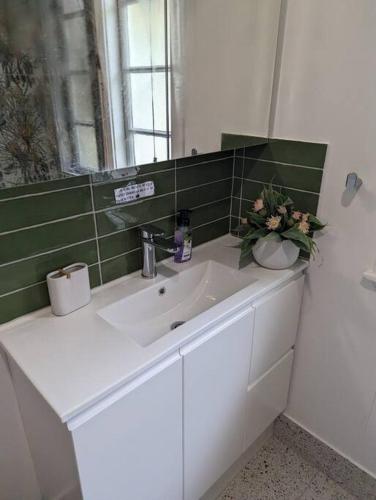 a bathroom with a white sink and a mirror at 3 bed cottage nestled at centre of 21 acres in Blackbutt in Blackbutt