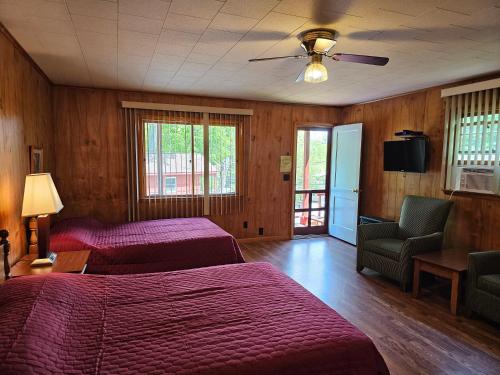a bedroom with two beds and a ceiling fan at The Gold Eagle in Lake George