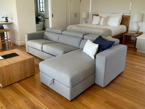 a living room with a couch and a bed at Seven Peaks Farm Stay in Beerwah