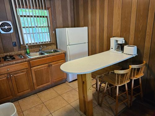 a kitchen with a counter and a white refrigerator at The Gold Eagle in Lake George