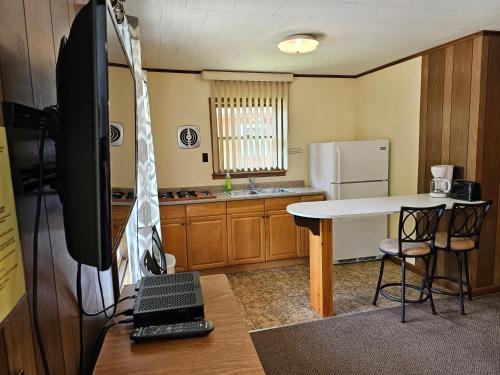a kitchen with a white table and a refrigerator at The Gold Eagle in Lake George
