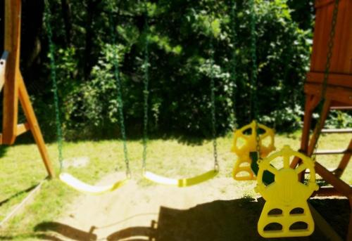 a swing in a playground with a yellow toy at The Gold Eagle in Lake George