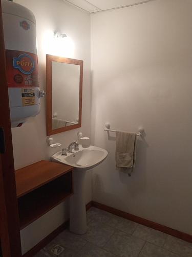 a bathroom with a sink and a mirror at 365 Dptos in Villa Regina