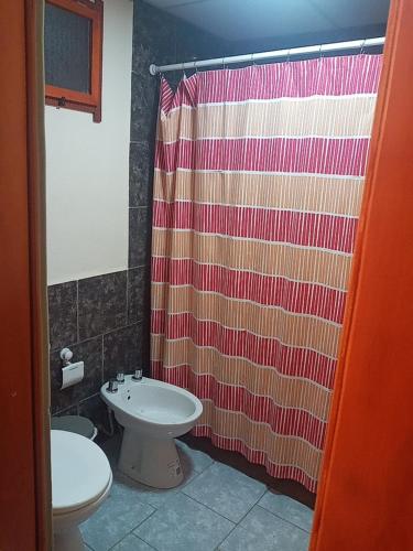 a bathroom with a sink and a shower curtain at 365 Dptos in Villa Regina