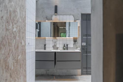 a bathroom with a sink and a mirror at hsueh_house in Yilan City