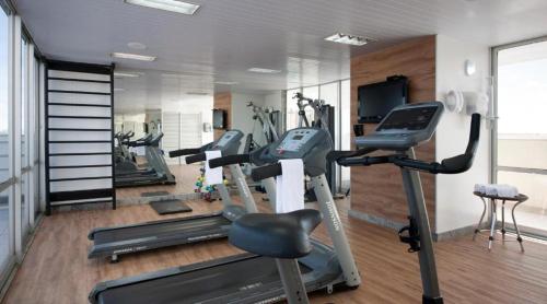 a gym with several tread machines in a room at Promoção - Flat em Brasília in Brasilia