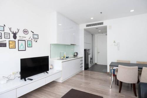 a living room with a tv and a kitchen at MyRehat Suites Bukit Ceylon in Kuala Lumpur