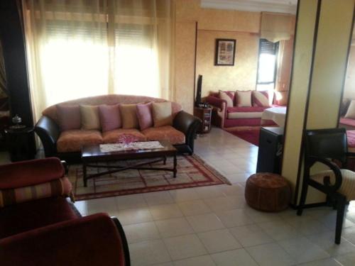 a living room with a couch and a coffee table at appartement TAza in Casablanca