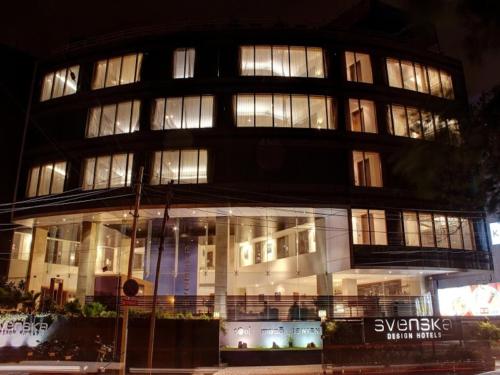 a large building with many windows at night at Svenska Design Hotel, Electronic City, Bangalore in Bengaluru