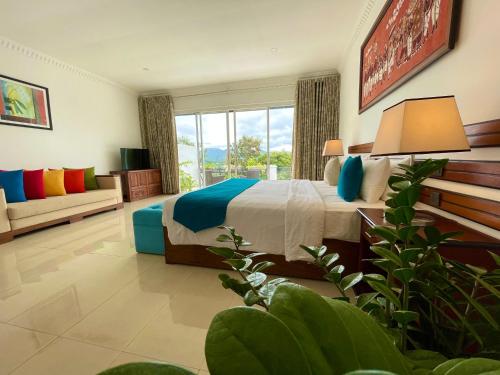 a hotel room with a bed and a couch at Elegant Hotel in Kandy