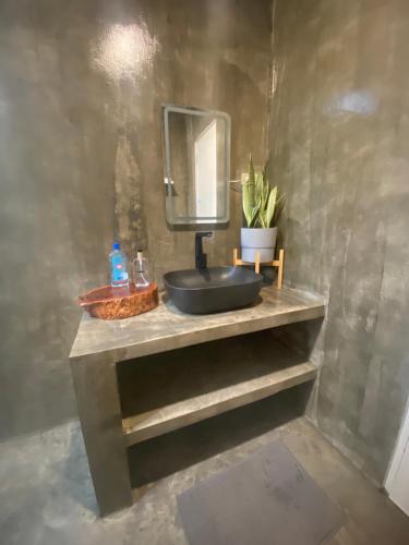 a bathroom with a sink and a mirror at Entire Villa near Surigao City in Surigao