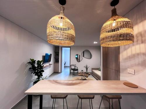 a dining room with two hanging lights and a table at Parallelo Loft Salento P3 in Salento