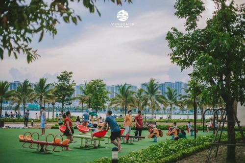 a group of people playing in a park at Apartment 1BR-FL22th-R103 Building-Vinhome Ocean Park in Hanoi