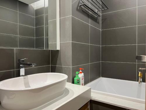 a bathroom with a white tub and a sink at Hanah Residence Chuỗi CHDV The Zei Hanoi in Hanoi