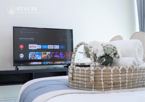 a wicker basket with a television in a room at Atria Sofo Suites - Petaling Jaya in Petaling Jaya