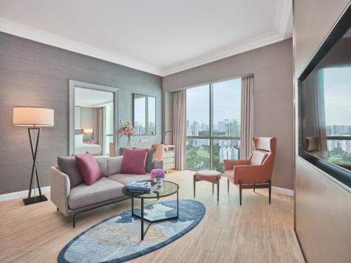 a living room with a couch and a chair at Grand Copthorne Waterfront in Singapore