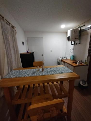 cocina con mesa de madera en una habitación en Monoambiente lindo y luminoso en San Carlos de Bariloche
