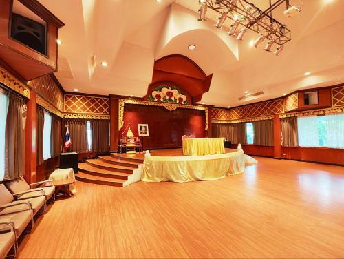 a large ballroom with two tables and chairs in it at Phu Pha Phung Resort in Suan Phung