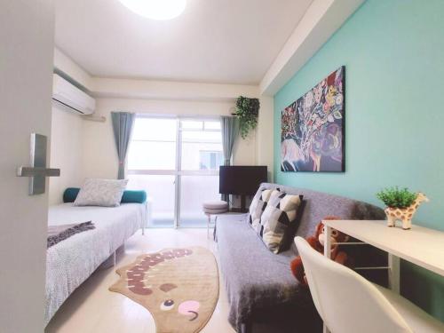 Una cama o camas en una habitación de 浦和STAY