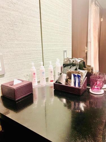 a counter with bottles of soap and other items on it at Asokono Hotel in Kami-seya