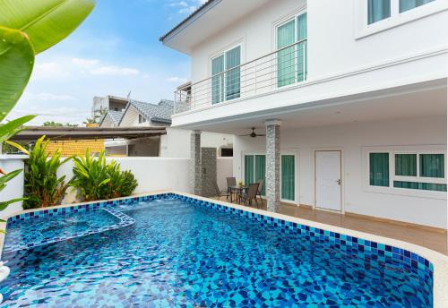 a swimming pool in front of a villa at Relax Pool Villa Near Walking Street,jacuzzi ,BBQ 5Bed 6Bath City house54 in Pattaya South