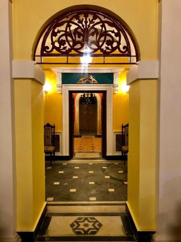 an entrance to a building with a tile floor at COSSIMBAZAR PALACE OF THE ROYS ( RAJBARI) in Cossimbāzār