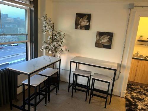 a dining room with two tables and chairs and a window at 1 Bedroom Apartment Downtown in Detroit