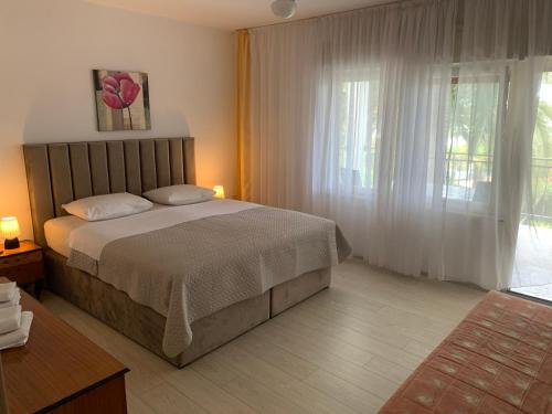 een slaapkamer met een bed en een groot raam bij The48 in Zadar