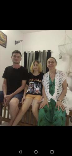 a group of three people sitting on a bench at CLIFF HEAVEN in Varkala