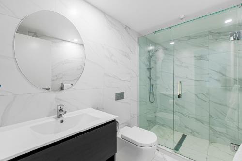 a bathroom with a shower and a toilet and a sink at The Surrey Hotel in Auckland