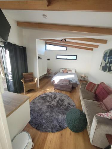 a living room with a bed and a couch at Bayside Bungalow in Cheltenham