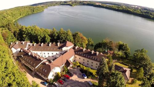an aerial view of a castle by a lake at Hotel Mazuria Country & SPA in Mrągowo